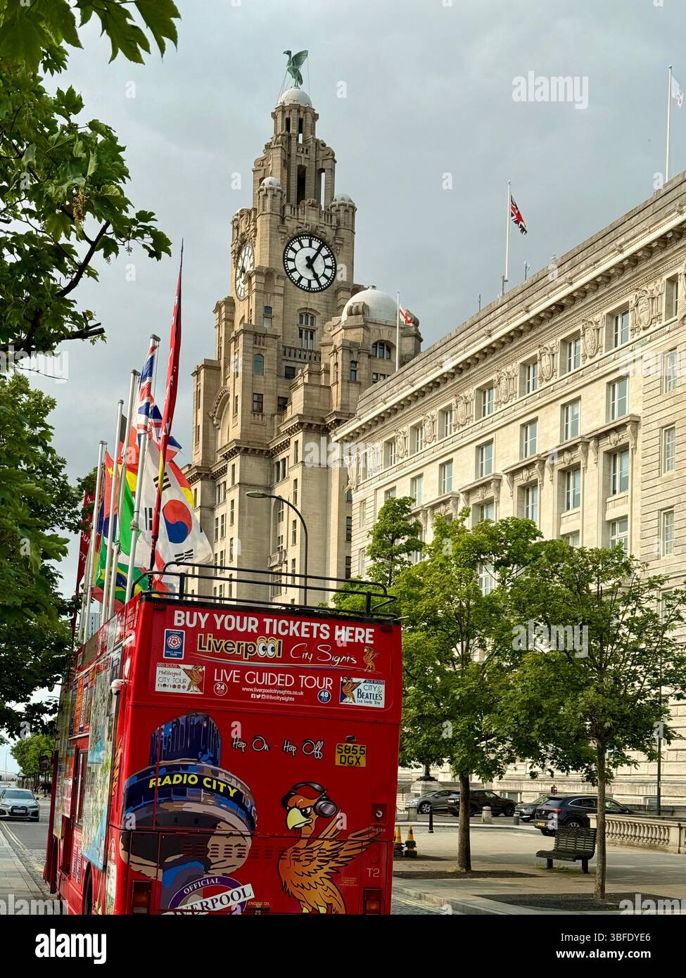 The Royal Liver Building and a city tour bus fitted out as a ticket office on Liverpool waterfront - Smartphone Captured Stock Image