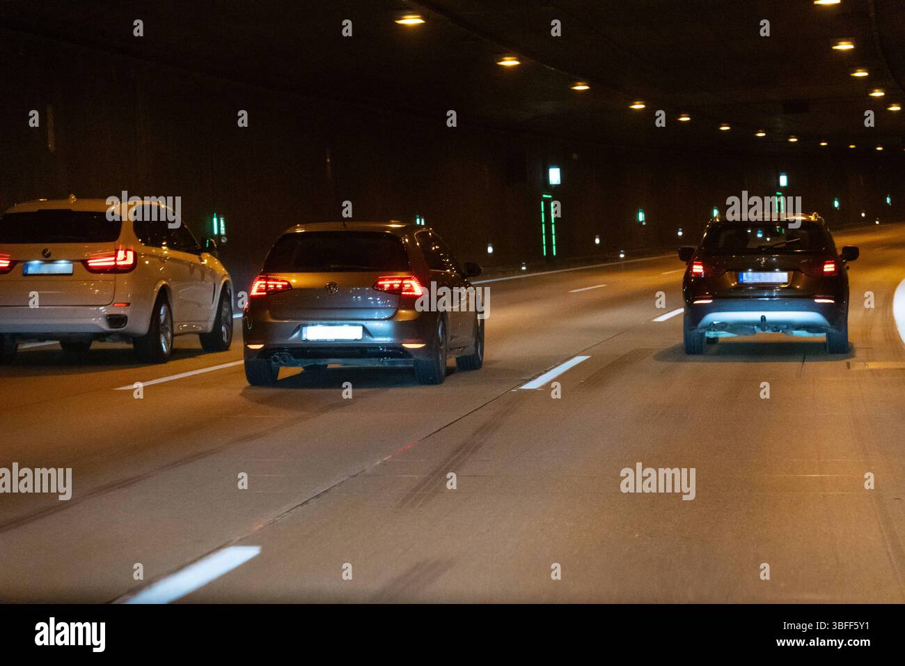 Munich, Bavaria, Germany - May 30, 2025: The Allach Tunnel near Munich shows flowing traffic under modern LED lighting, with clear roadway guidance *** Der Tunnel Allach bei München zeigt fließenden Verkehr unter moderner LED-Beleuchtung, mit klarer Fahrbahnführung Stock Photo