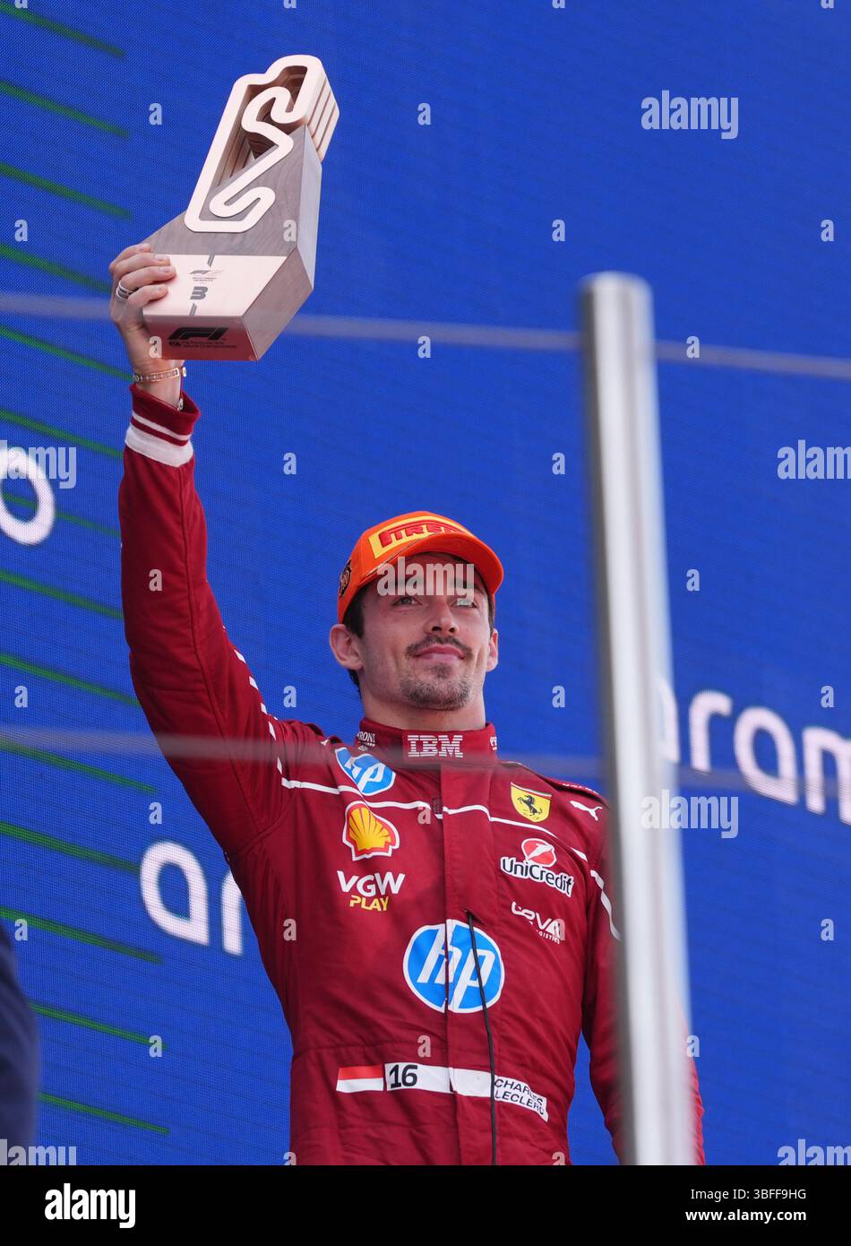 Ferrari's Charles Leclerc celebrates on the podium after finishing ...
