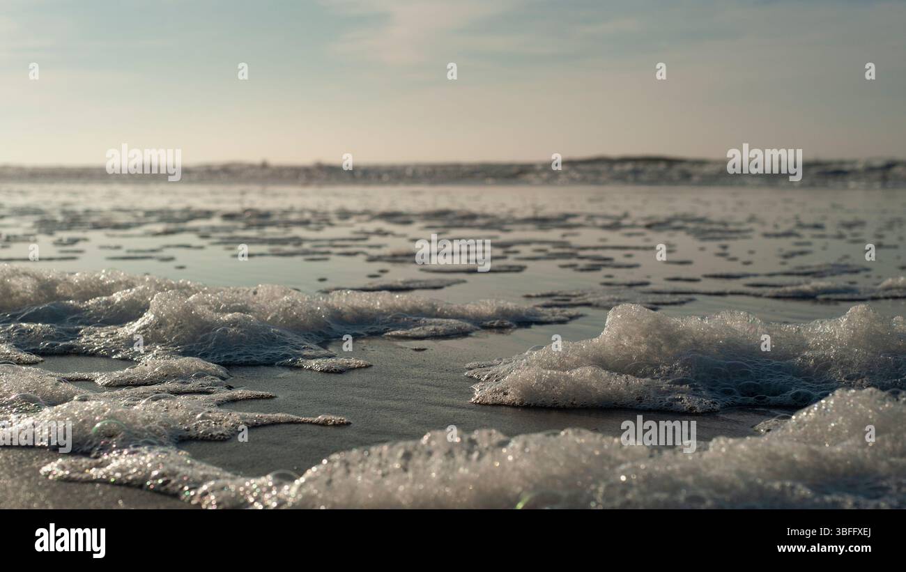 Schaum am Strand Stock Photo