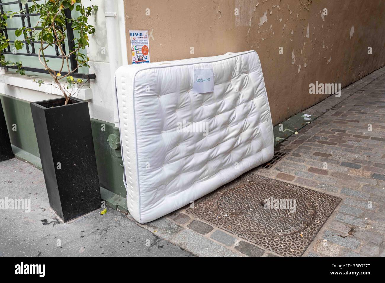 Clean looking mattress leaning against wall at Impasse Santa-Henriette in Clignancourt district of Paris, France Stock Photo
