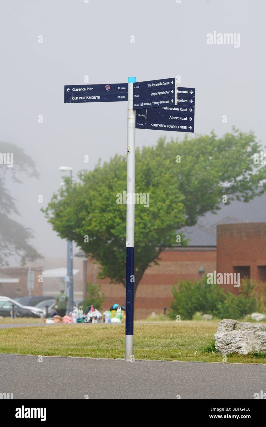 Outdoor Wayfinding Signpost Alongside Grassy Background in Urban Area. Portsmouth, UK Stock Photo