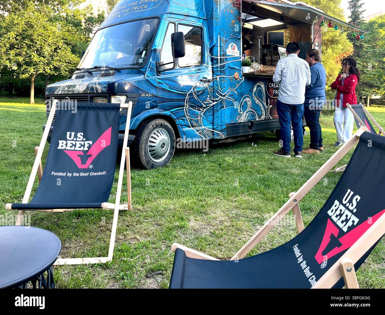 Street food truck offering grilled surf and turf meals at garden party in Sofia Bulgaria, Eastern Europe, Balkans, EU - Smartphone Captured Stock Image