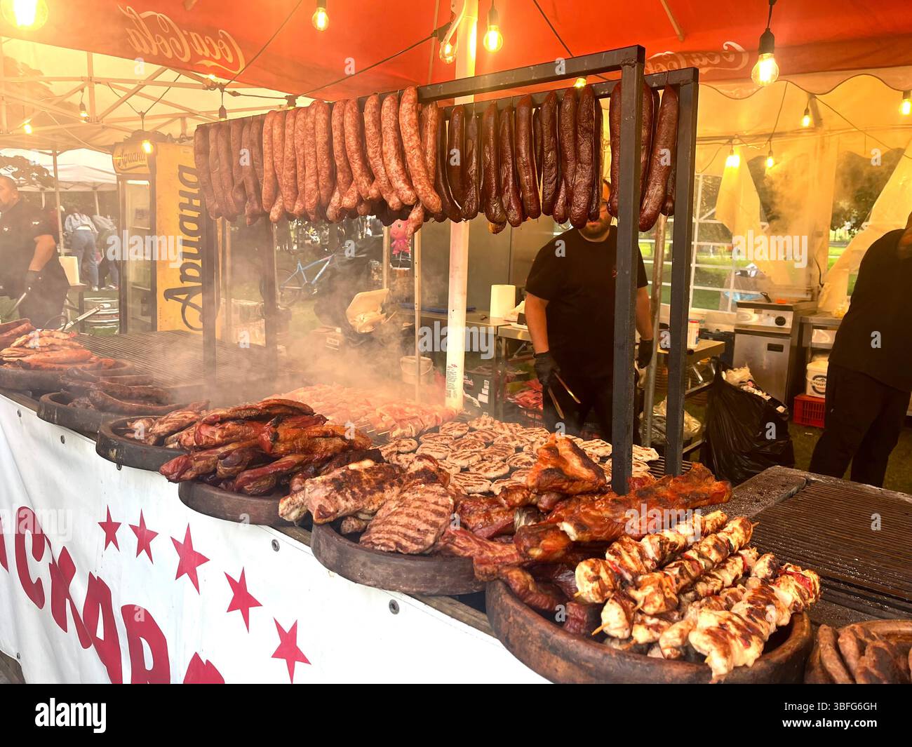 Barbeque grilled sausages stall at an urban garden happening in Sofia Bulgaria, Eastern Europe, Balkans, EU - Smartphone Captured Stock Image