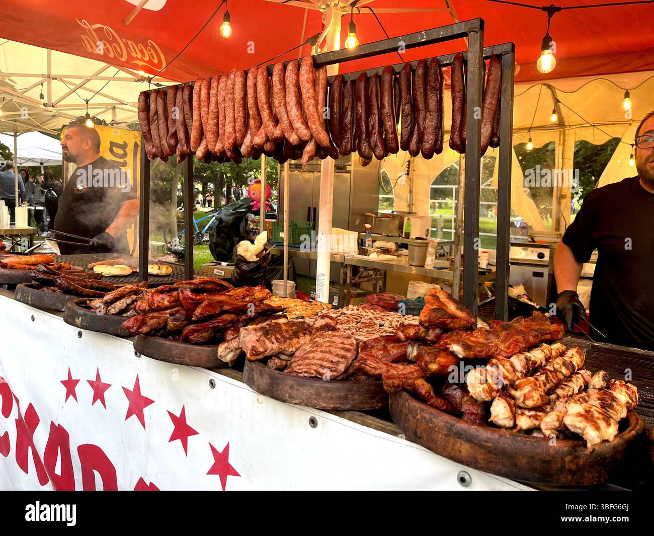 Barbeque grilled meat and sausages stall at an urban garden happening in Sofia Bulgaria, Eastern Europe, Balkans, EU - Smartphone Captured Stock Image