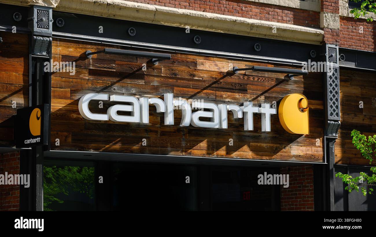 Spokane, WA, USA - May 2, 2025; Carhartt business sign in closeup on wooden panel Stock Photo