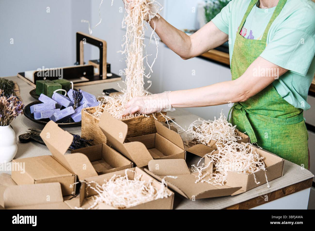 Person fills kraft boxes with shredded paper as part of eco-conscious ...