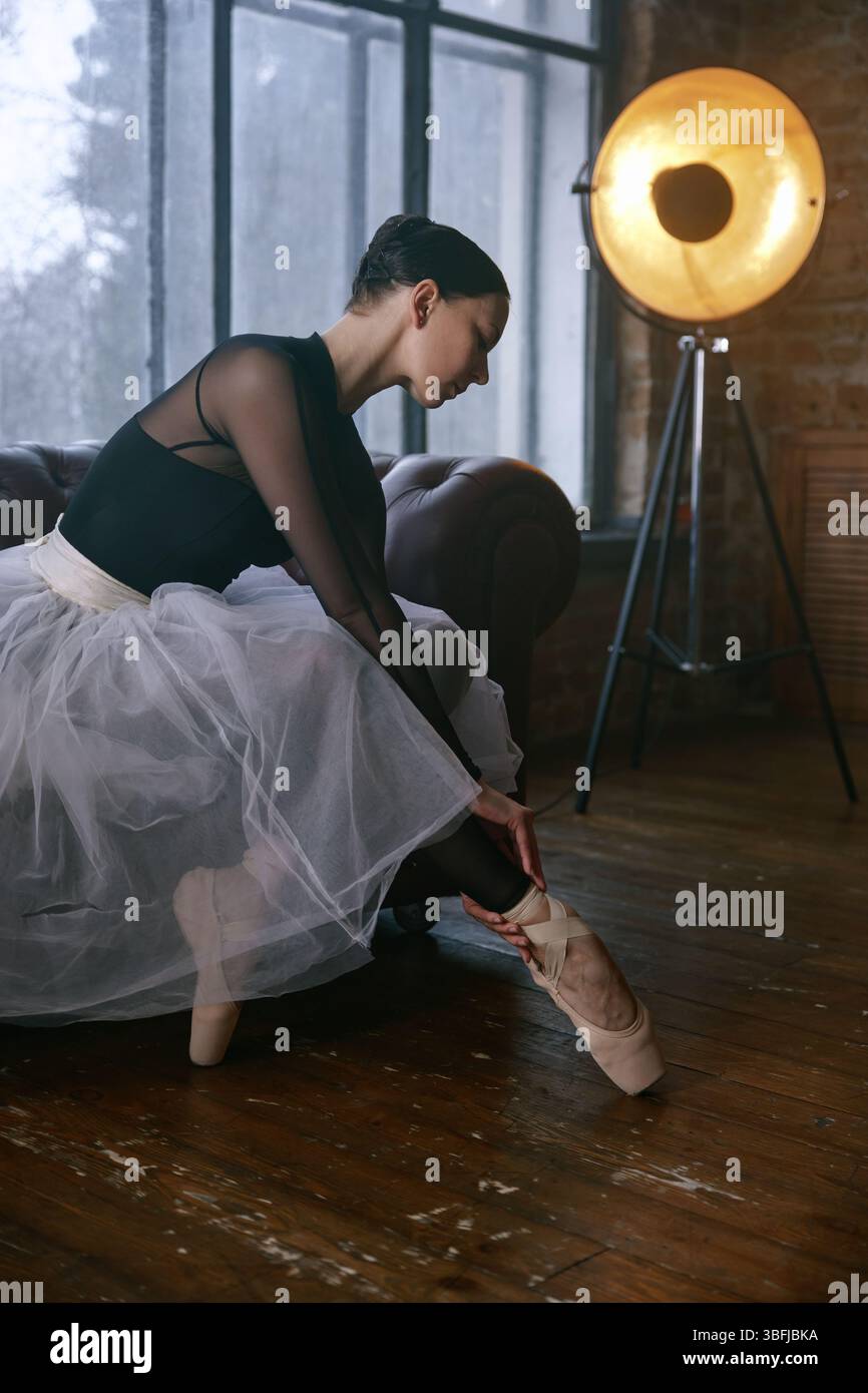 An elegant ballet dancer captured in a beautifully designed studio setting Stock Photo