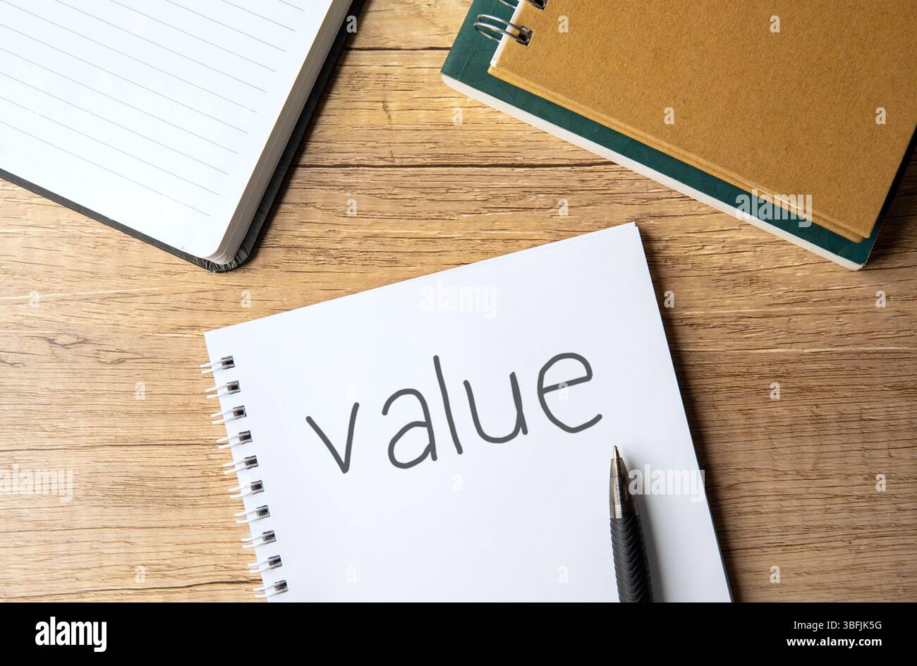 A top-down view of a notebook with the word "value". Stock Photo