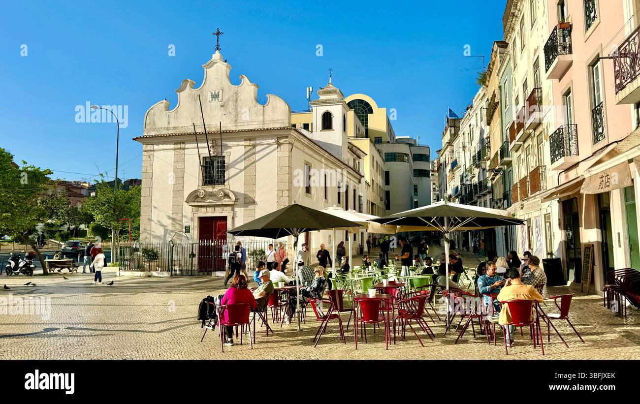 Alfresco dining in a plaza by Capela de Nossa Senhora da Saúde or Chapel of Our Lady of Health in Mouraria district of Lisbon Portugal - Smartphone Captured Stock Image