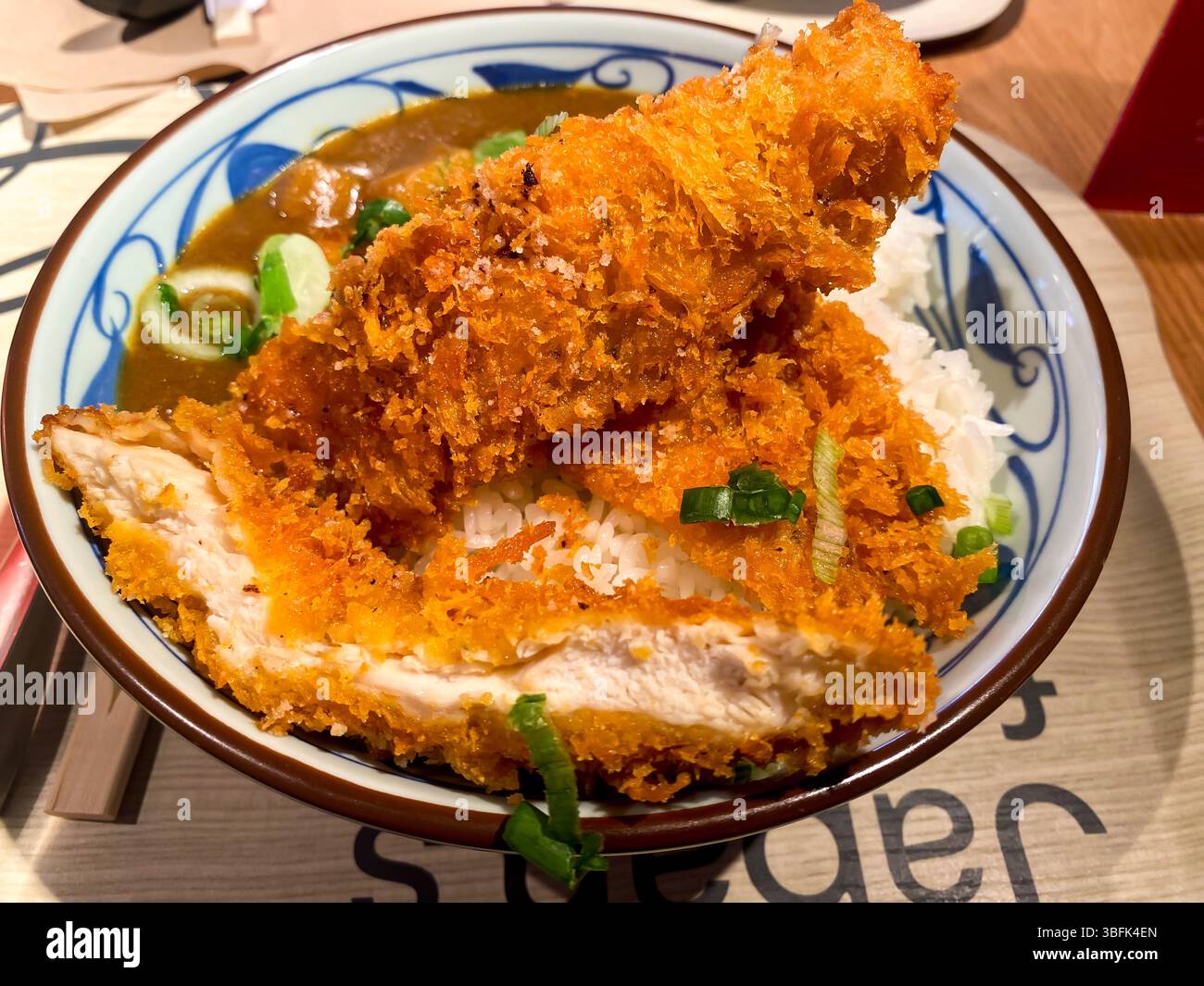 Close up view of a bowl of Japanese chicken katsu curry served with rice - Smartphone Captured Stock Image