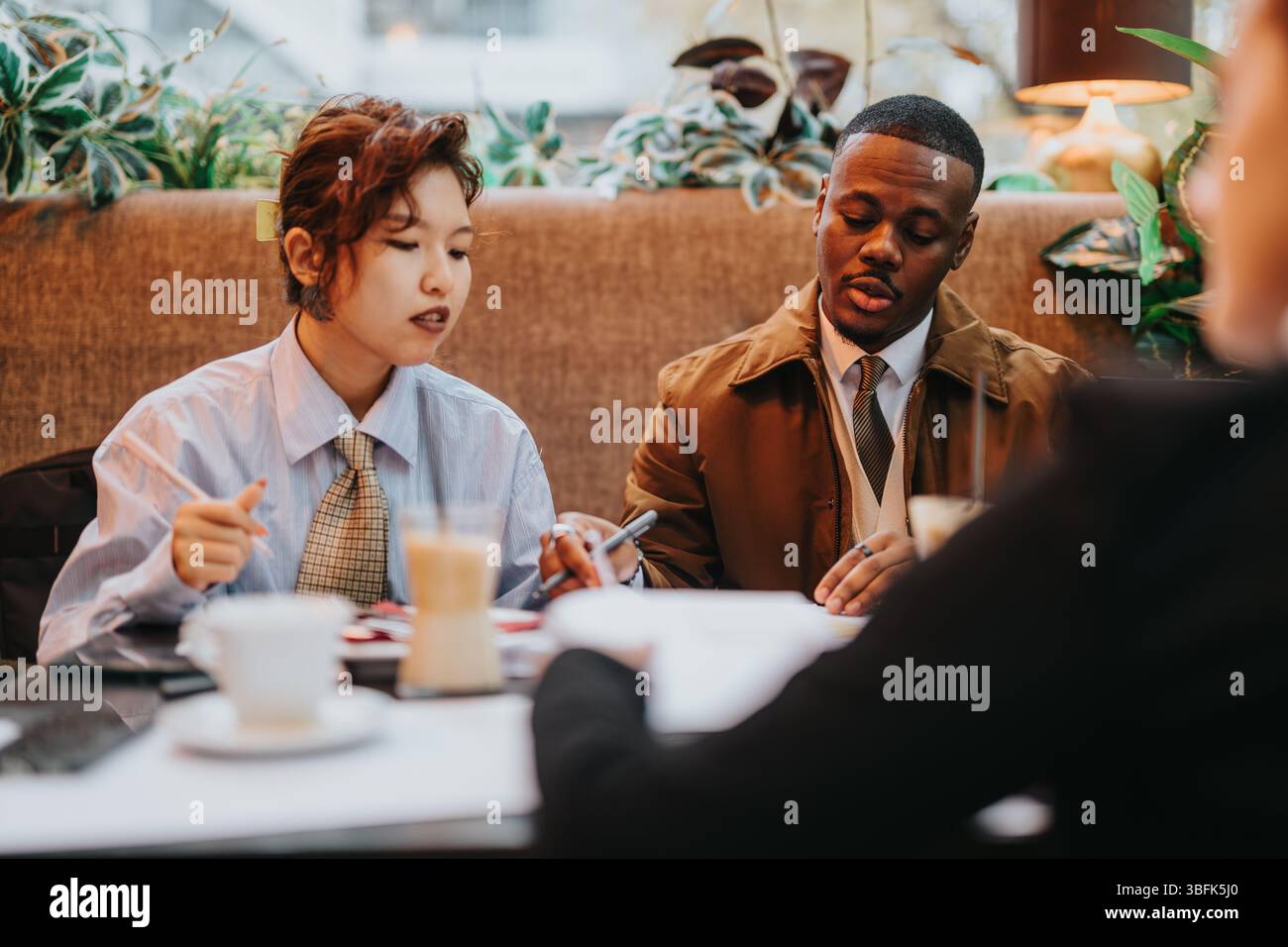Collaborative Business Discussion Between Multiracial Professionals, Teamwork Atmosphere Stock Photo