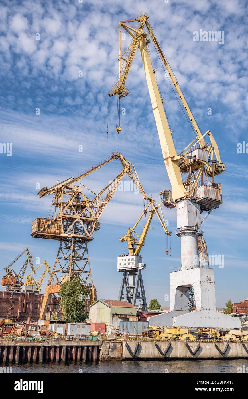 Large cranes working in the shipyard. Industrial landscape. Stock Photo