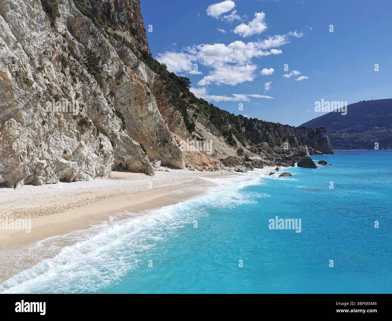 Turquoise waters and pristine white sand and shingle of Afales beach on the north coast of Ithica island in Greece. - Smartphone Captured Stock Image