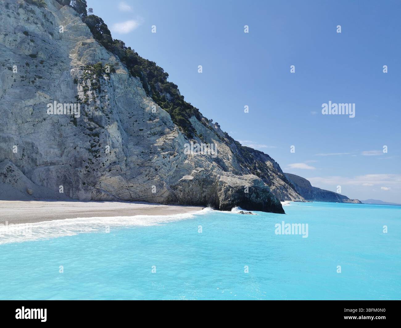 The white cliffs and turquoise waters of Egremni beach on the western side of Lefkada island in Greece. This stunning area can only be reached by boat. - Smartphone Captured Stock Image
