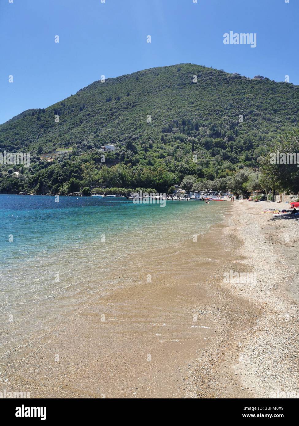 Desimi pebble beach near Nidri on Lefkada Island in Greece. A sheltered bay which is great for boating, paddleboarding, snorkelling and swimming. - Smartphone Captured Stock Image