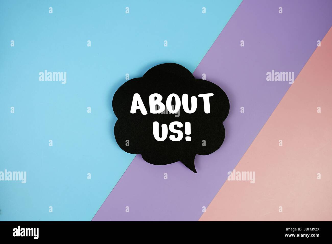 About Us text on speech bubble top view on blue, purple and pink ...