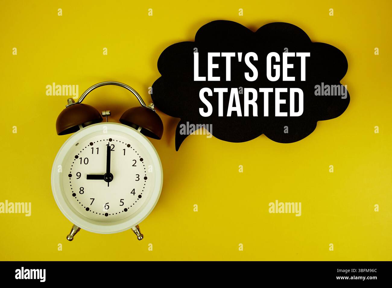 Let's Get Started text on speech bubble top view on yellow background Stock Photo