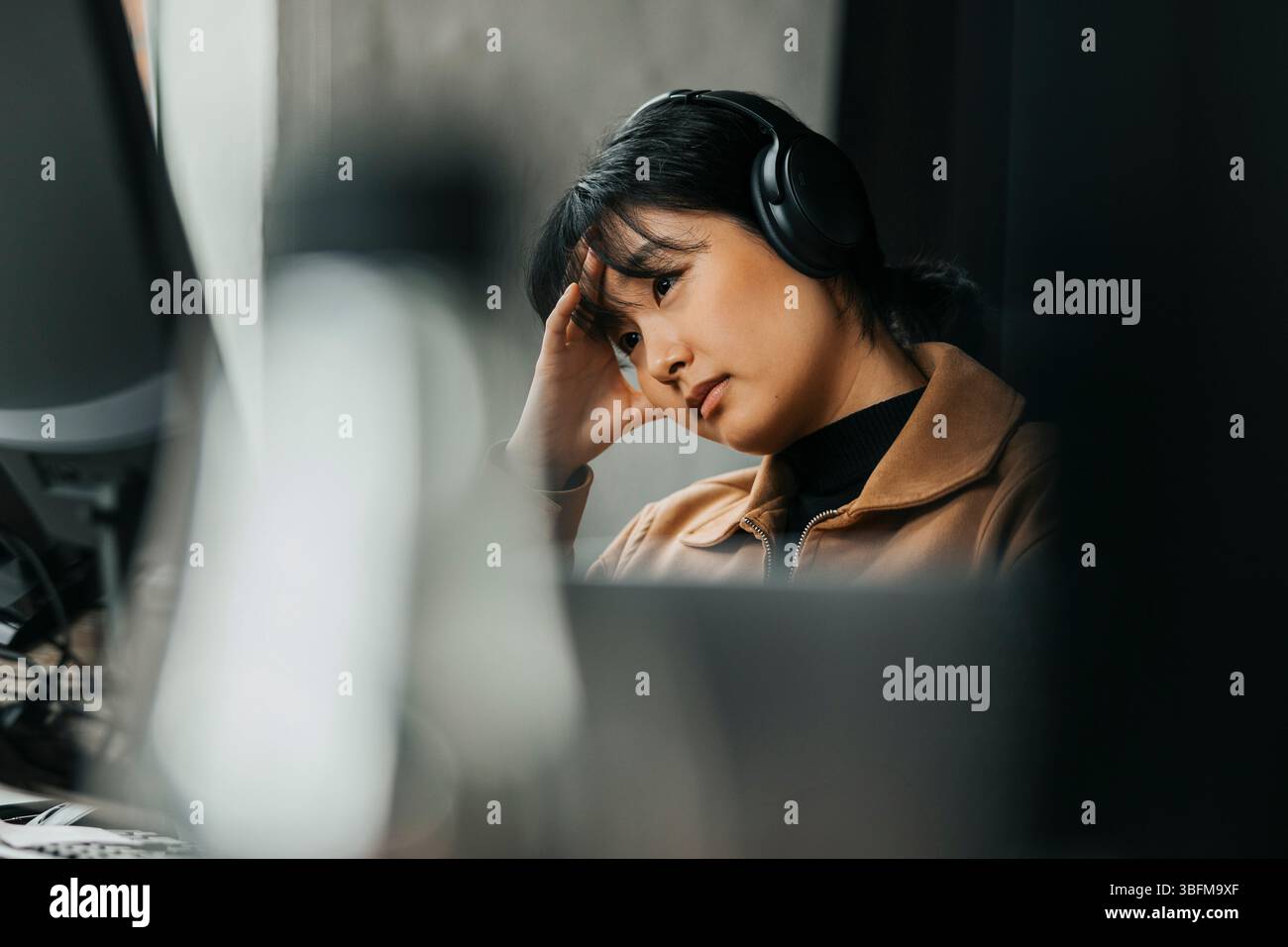Frustrated female computer programmer at tech start up office Stock Photo