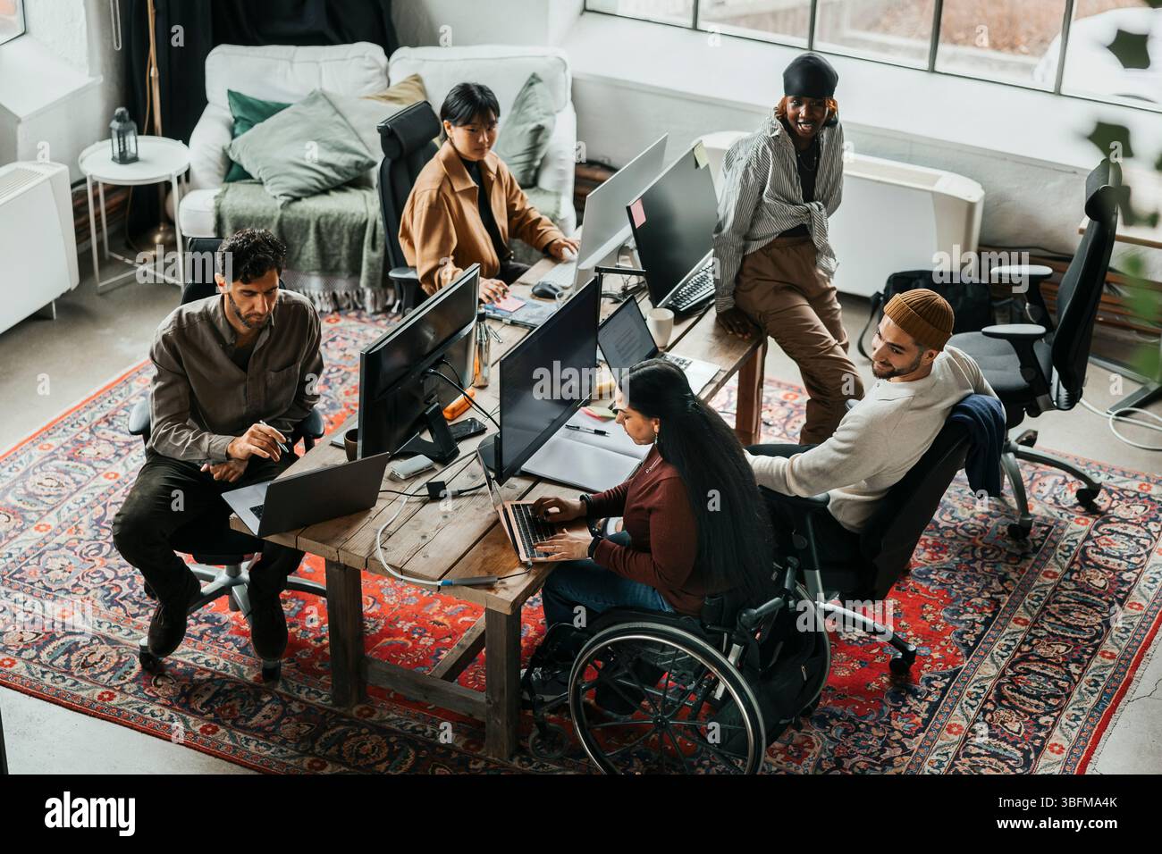 Team of programmers working together at tech start up office Stock Photo