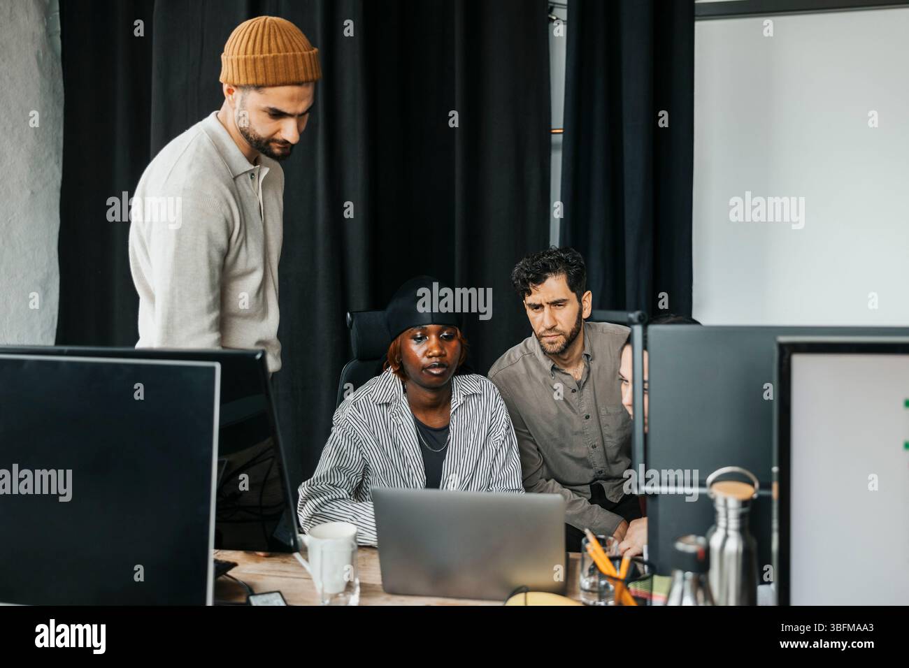 Team of diverse computer programmers working together at office Stock Photo