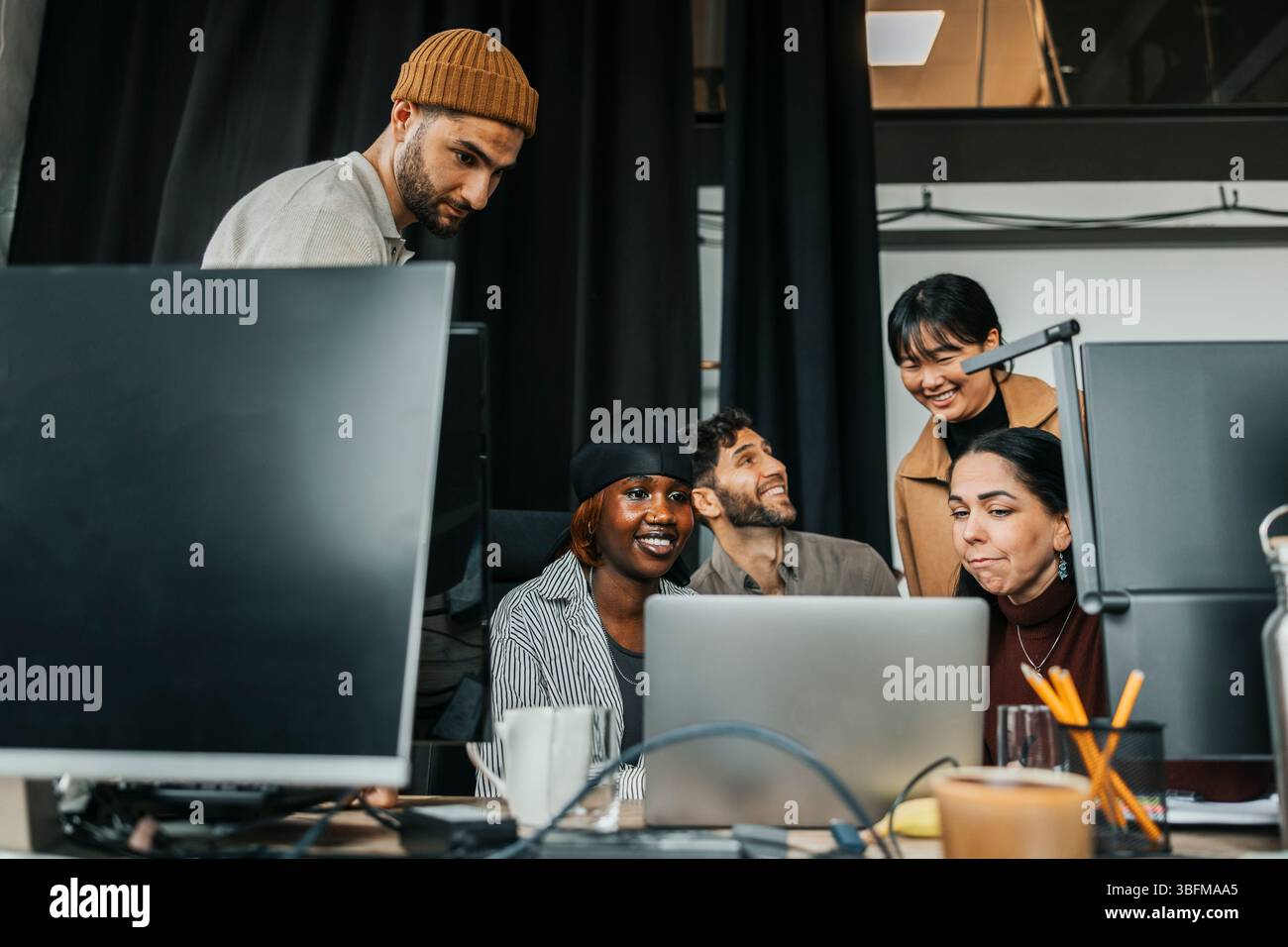 Team of happy computer programmers at tech start up office Stock Photo