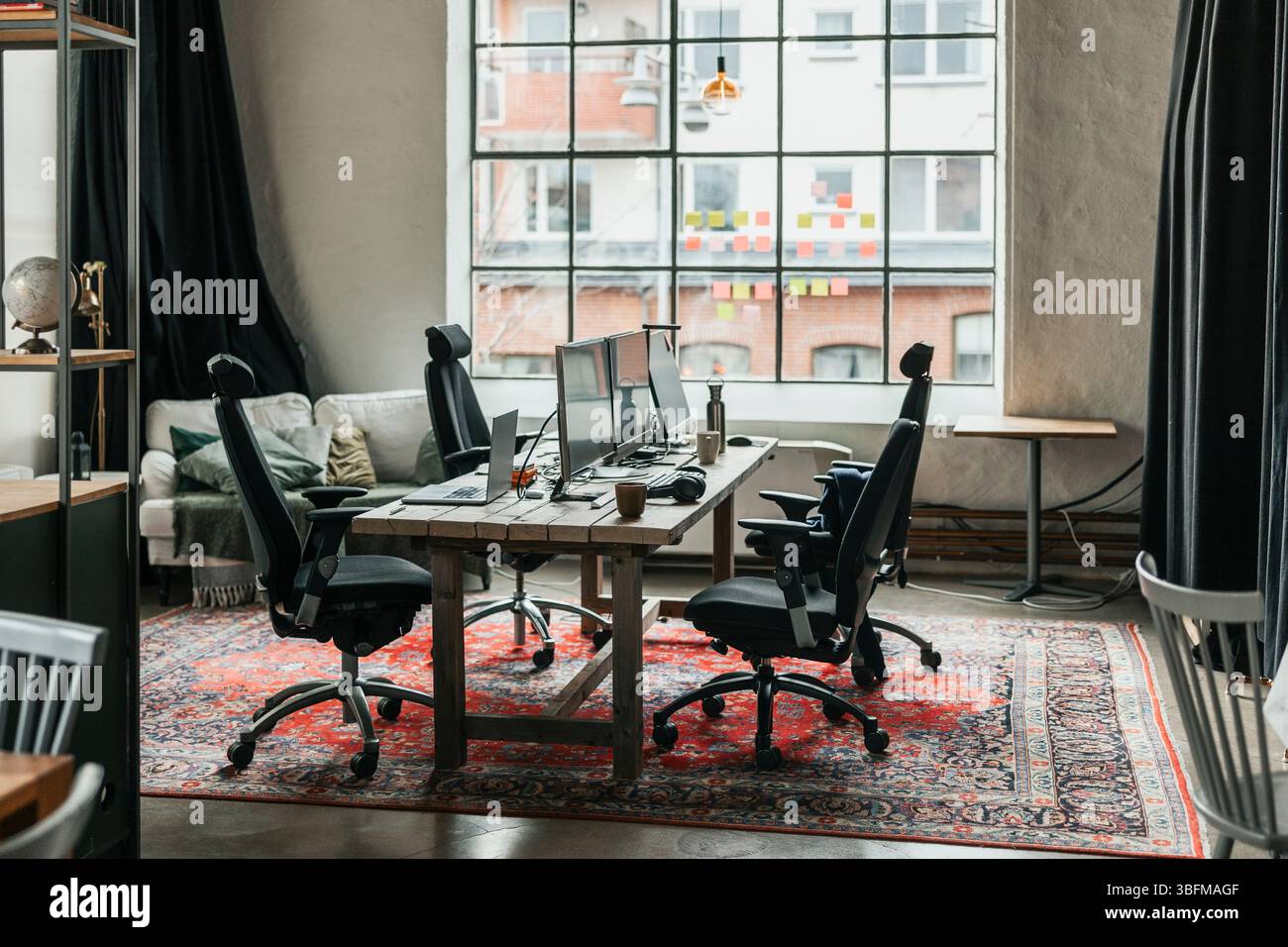 Empty modern office interior with computers on chairs and tables Stock Photo