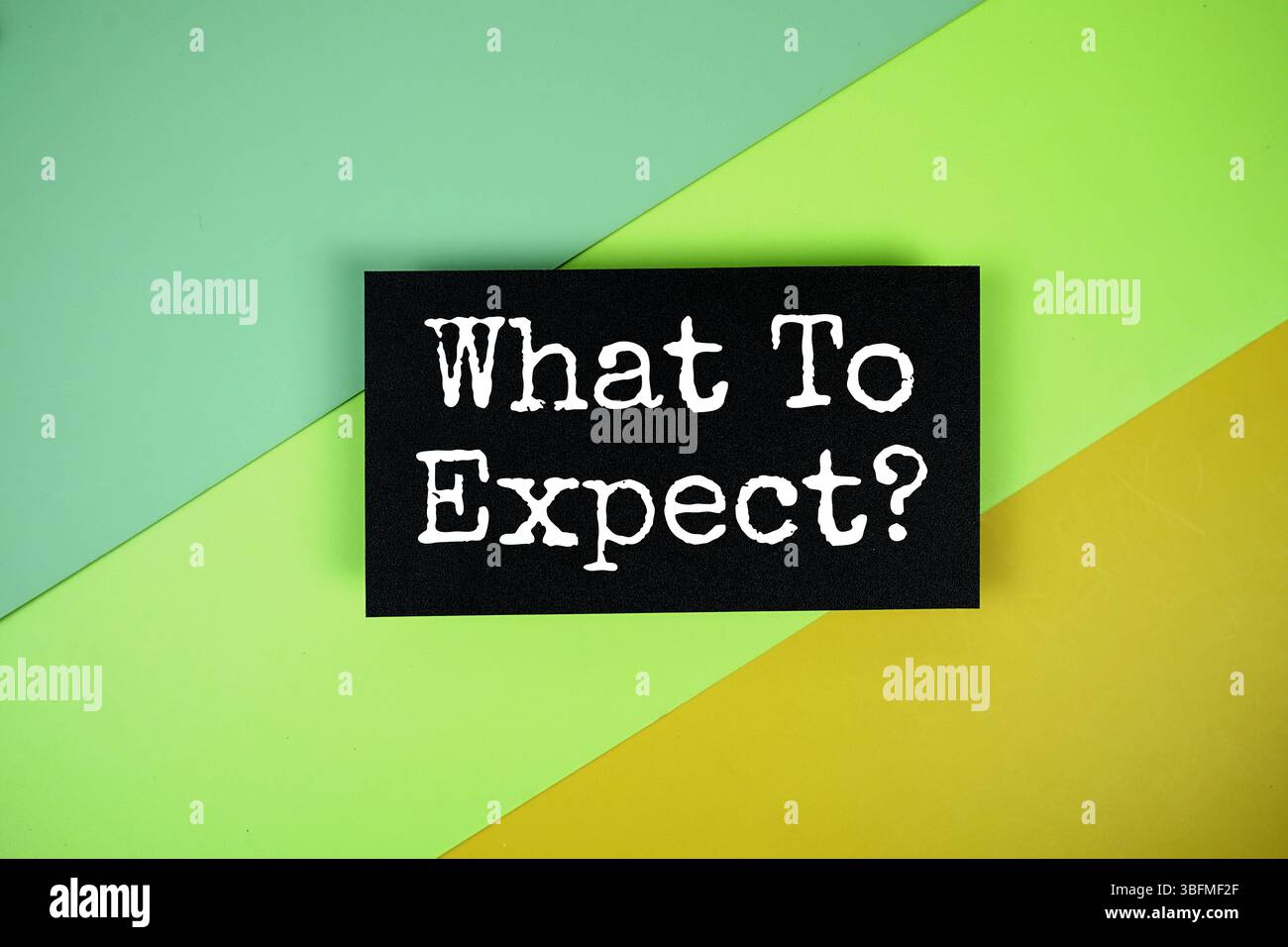 Expect A Text What To Expect? text on paper card on green and yellow geometric ...