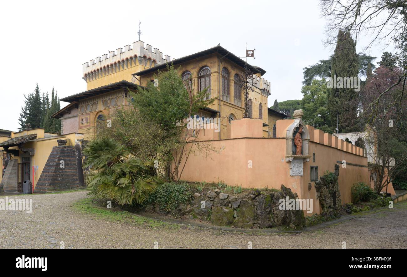 Exterior view of Villa Stibbert, a 19th-century eclectic villa with neo-Gothic elements, surrounded by garden and stone wall, Florence, Italy. Stock Photo