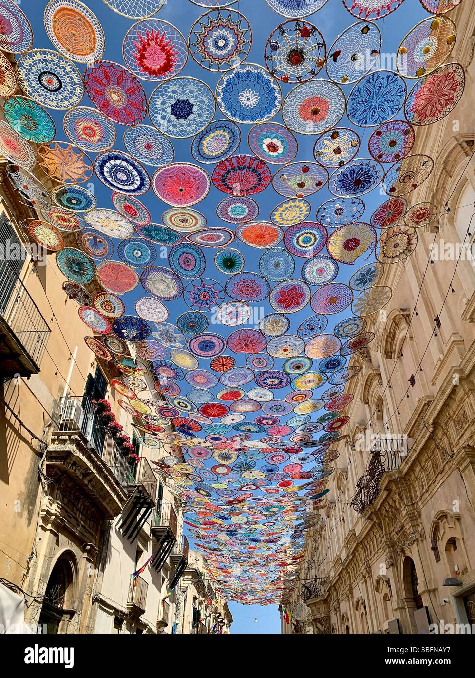 A kaleidoscope of colour above the streets of Noto, Sicily. Stock Photo
