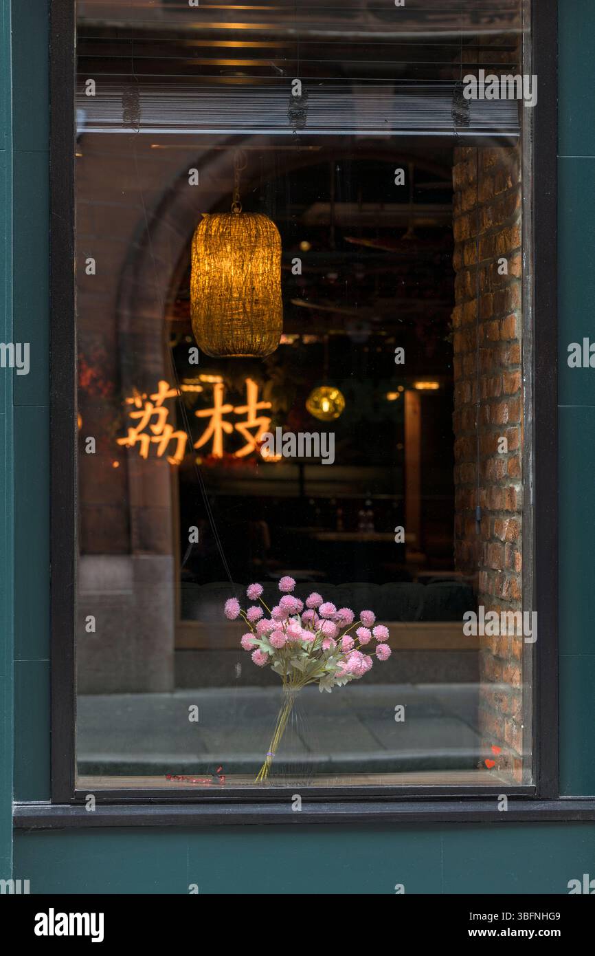 Flowers in the window of a Chinese restaurant, Glasgow, Scotland, UK, Europe Stock Photo