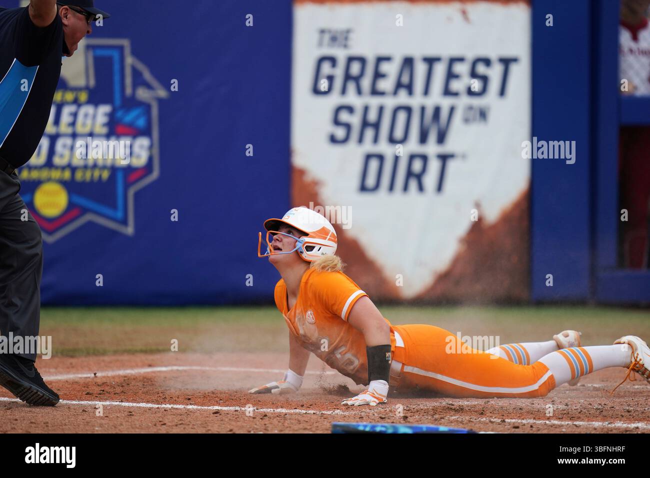 Tennessee infielder Ella Dodge (25) slides safely into home during an