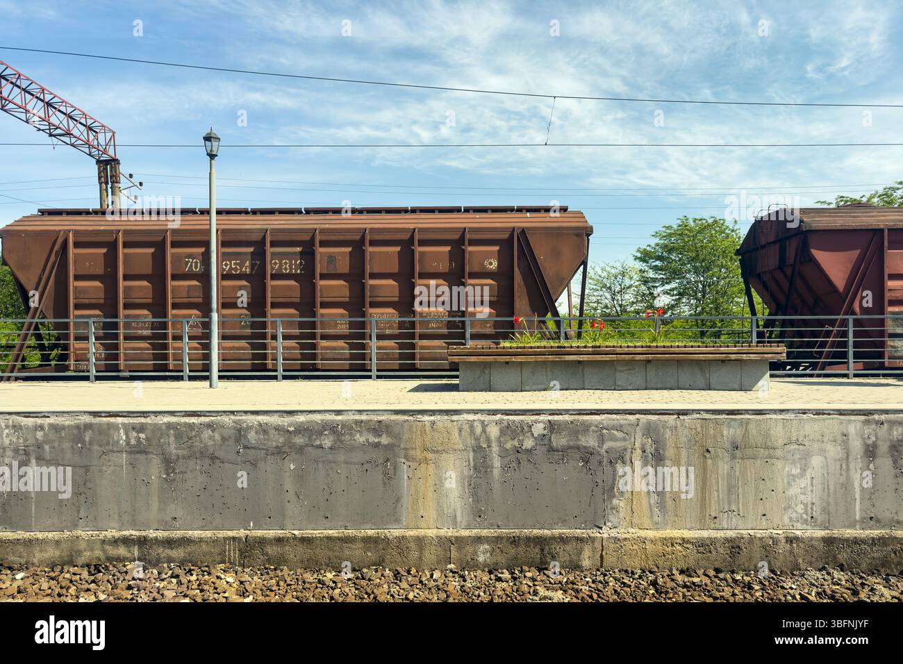 Freight railcars at railway station platform in Kutaisi, Georgia, on a sunny day. No people. Stock Photo