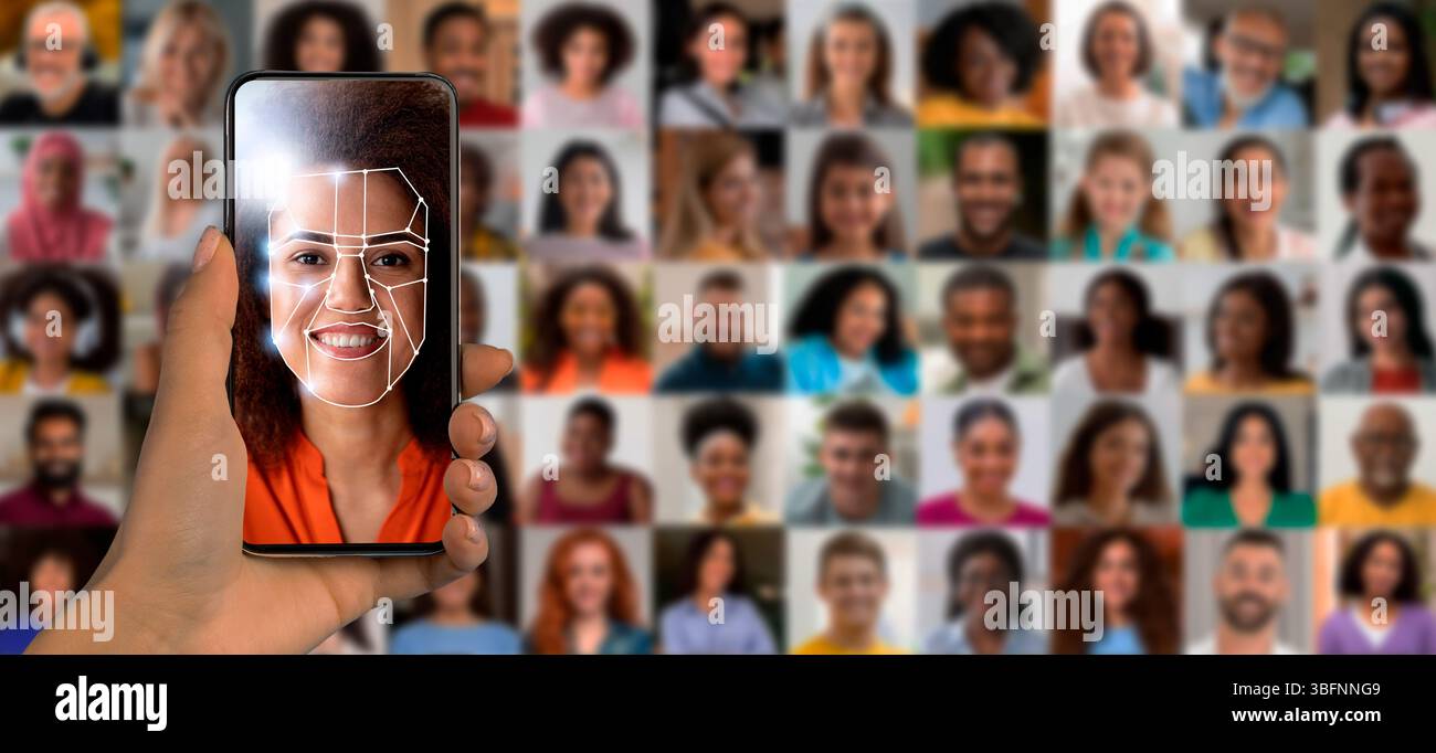 A hand holds a smartphone displaying facial recognition software Stock Photo
