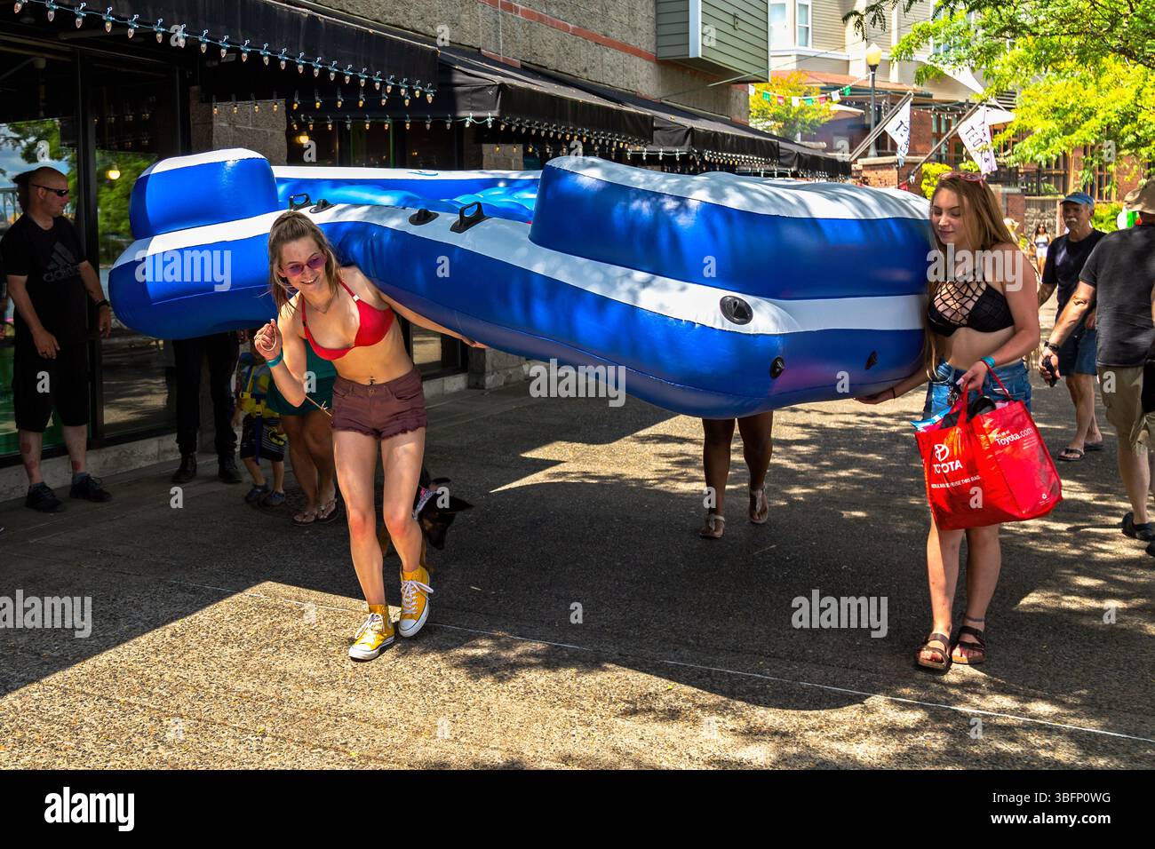 The Big Float, Portland, Oregon - July 13th 2019: Two women carry a ...