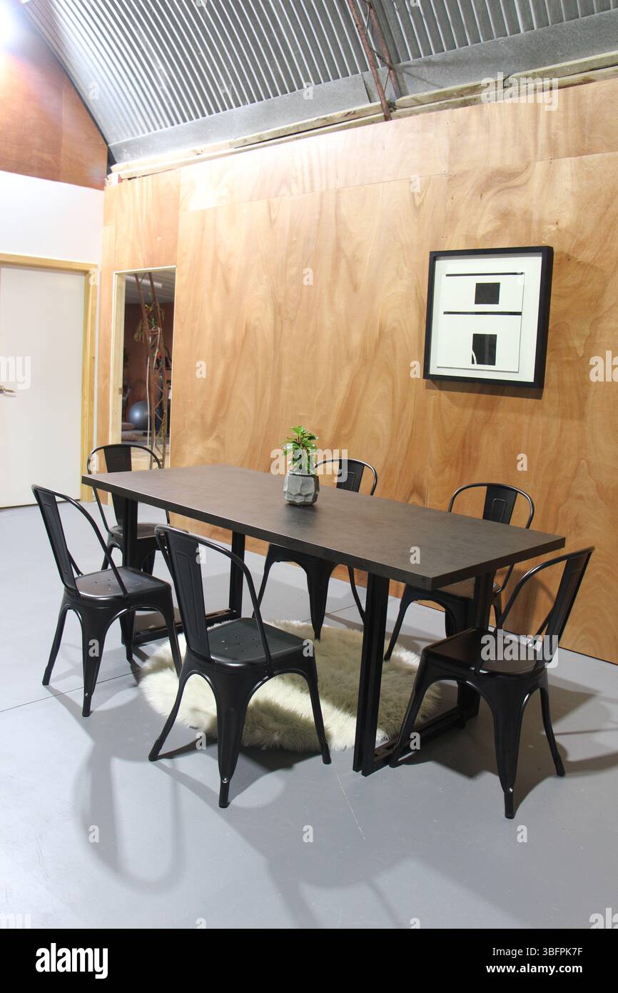 Lets sit - table and chairs inside a shed Stock Photo