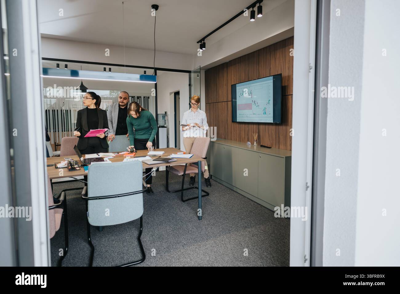 Diverse employees collaborating in a modern office during a business ...