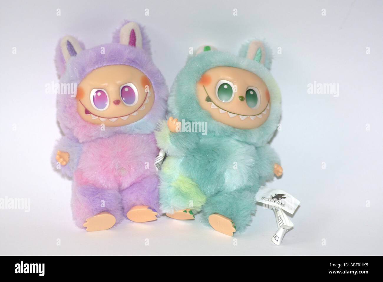 Two playful Labubu toy figures in a fluffy green and pink monster ...