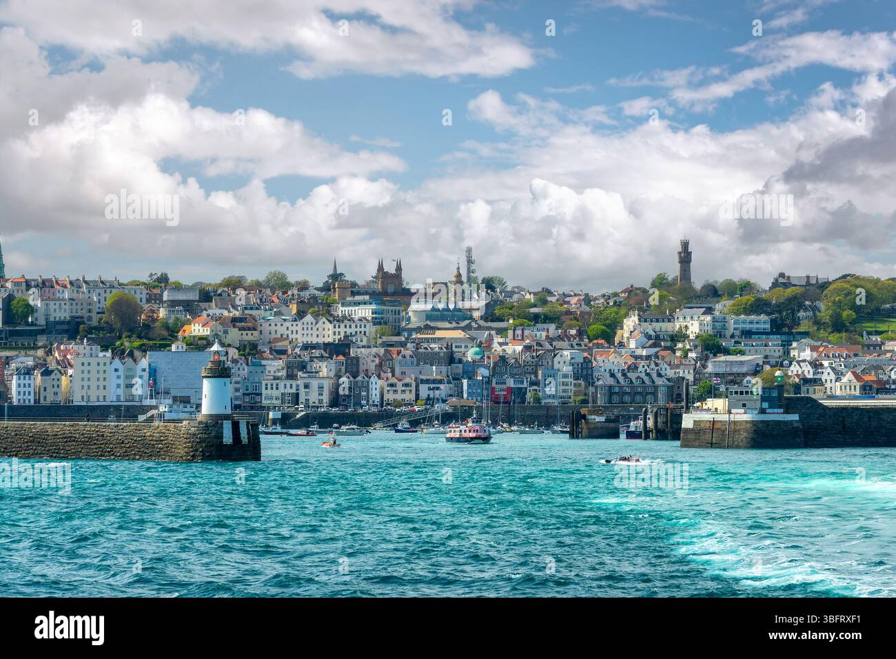 View of the harbor, the lighthouse and the town of St Peter Port in Guernsey, Channel Islands Stock Photo
