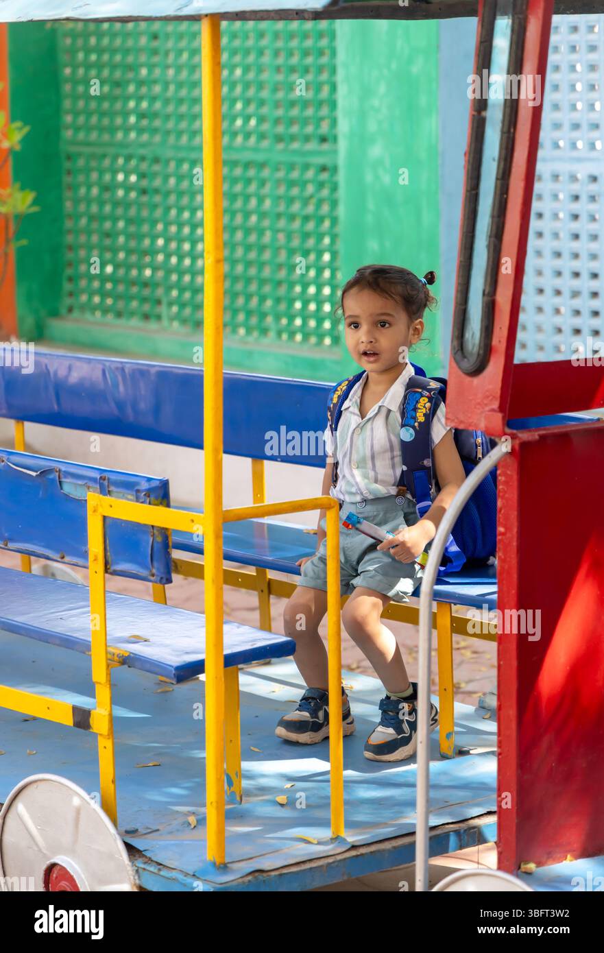toddler enjoying dummy train at outdoor preschool activity Stock Photo