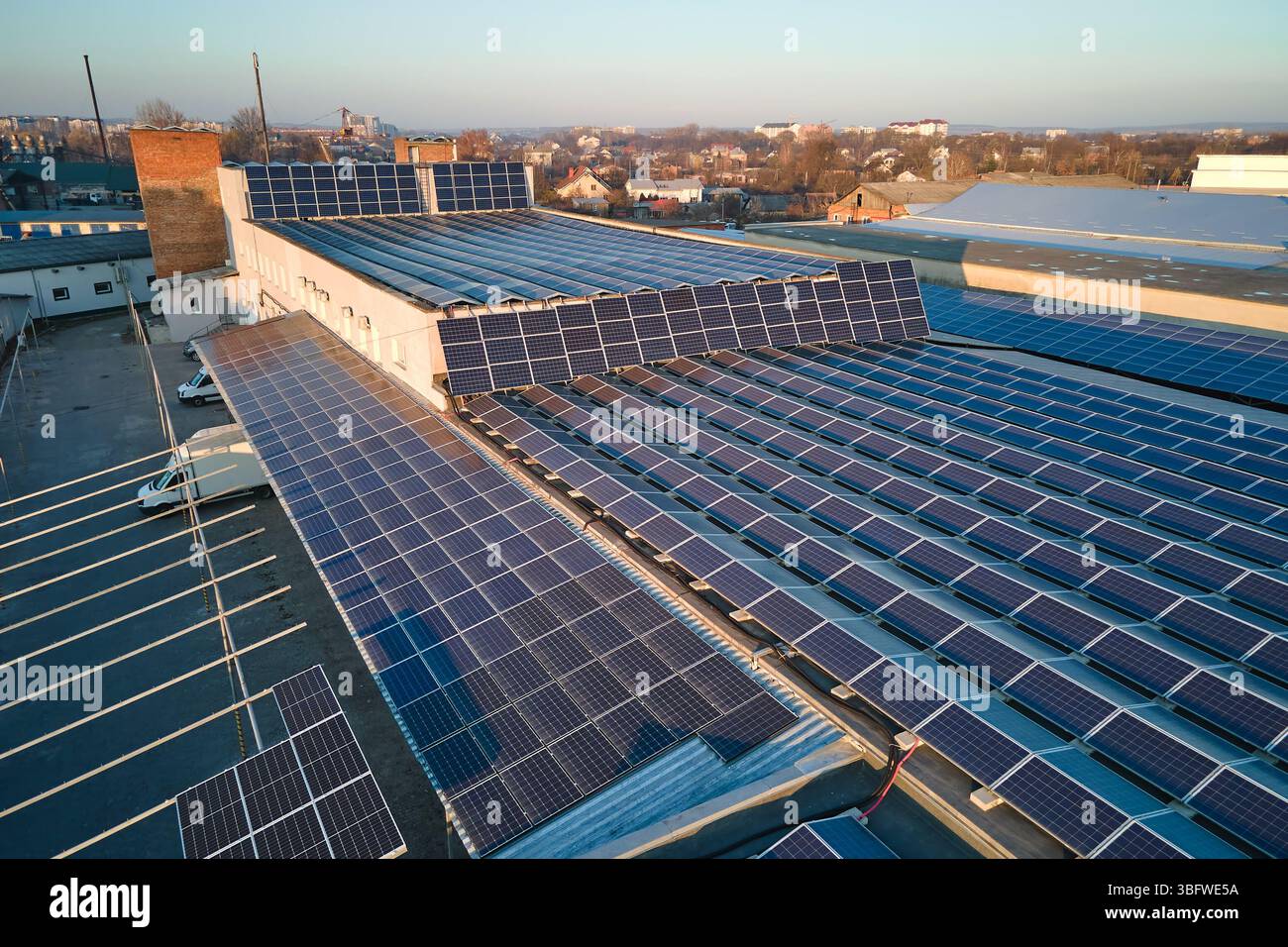 Aerial view of blue photovoltaic solar panels mounted on industrial ...