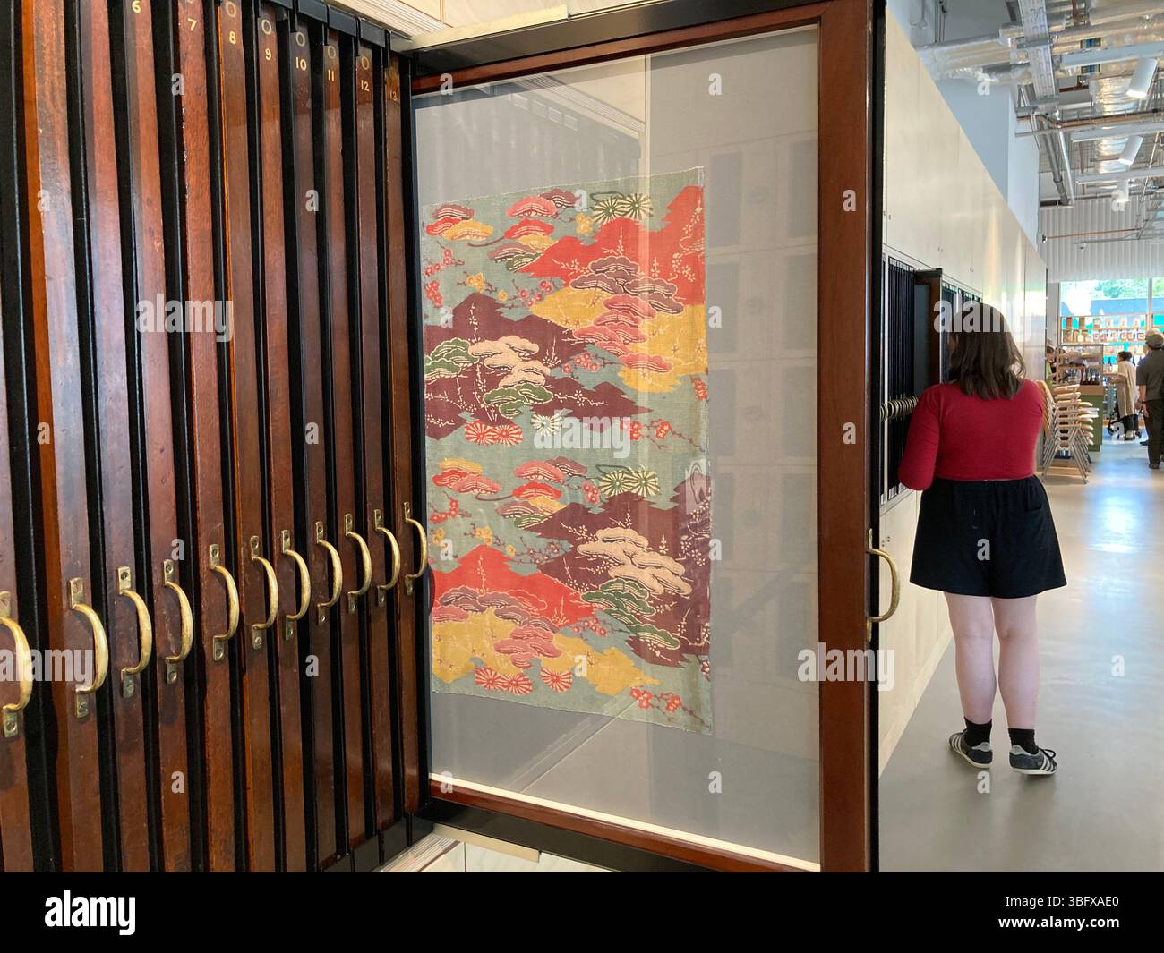 Textile samples on display in the cafeteria area at V&A East Storehouse, Queen Elizabeth Olympic Park, London, UK - Smartphone Captured Stock Image
