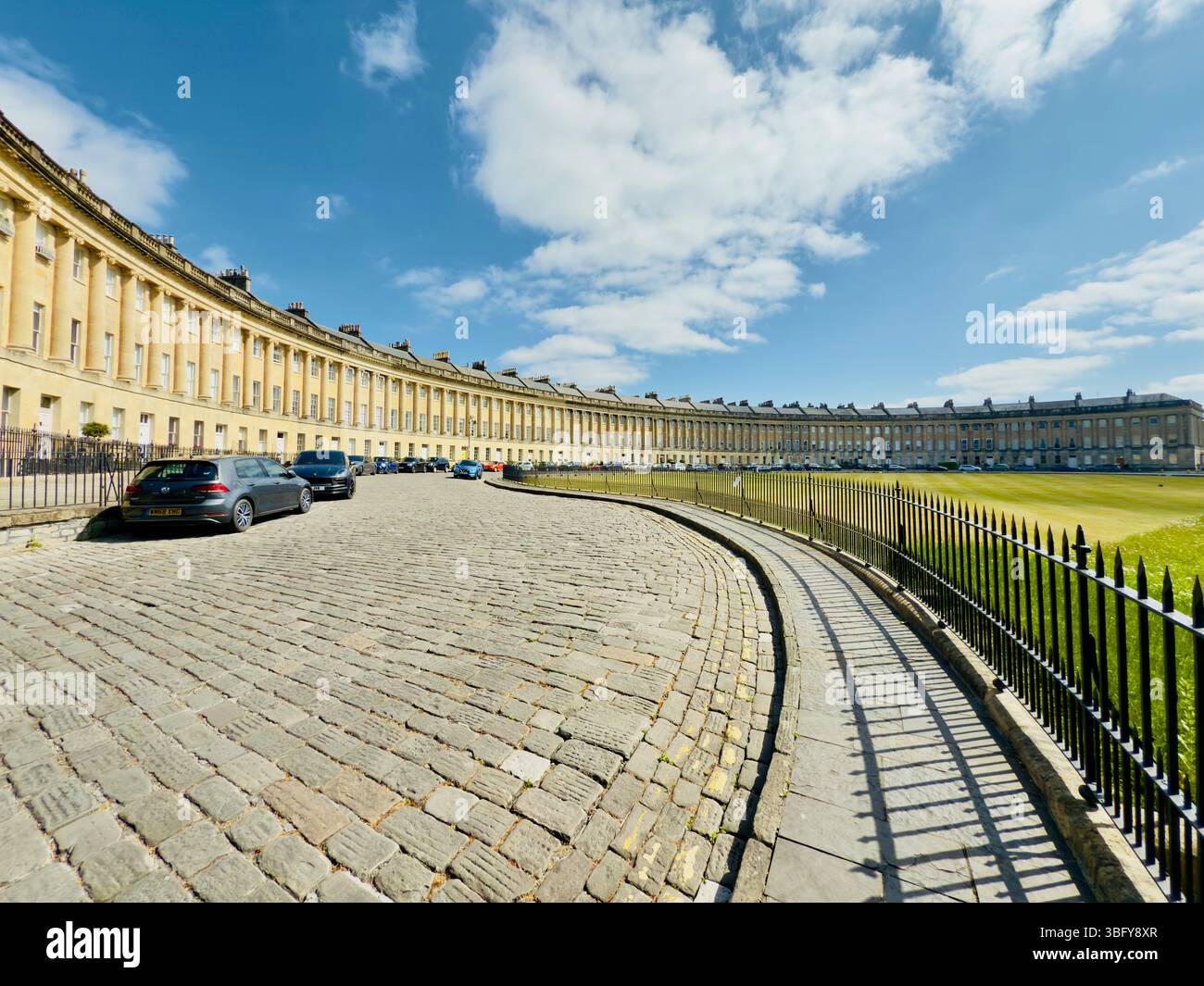 BATH, ENGLAND – MAY 17, 2025: The Royal Crescent in Bath showcases its sweeping Georgian architecture under a bright blue sky. - Smartphone Captured Stock Image