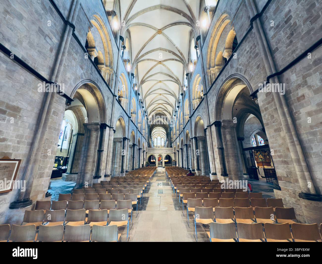 CHICHESTER, ENGLAND – MAY 16, 2025: The interior of Chichester Cathedral featuring gothic arches and rows of chairs along the nave. - Smartphone Captured Stock Image