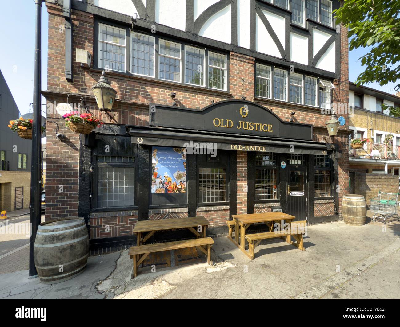LONDON, ENGLAND – AUGUST 15, 2023: The exterior of the Old Justice Pub, a traditional Tudor-style public house. - Smartphone Captured Stock Image