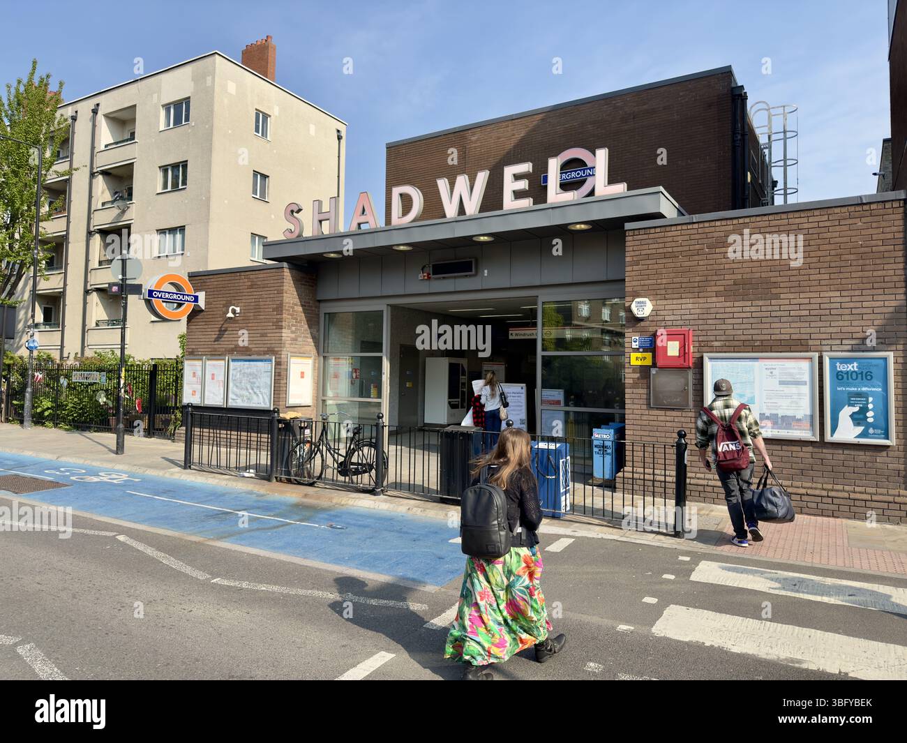 LONDON, ENGLAND – APRIL 27, 2025: People walk near the entrance of the Shadwell Overground station in London, England. - Smartphone Captured Stock Image