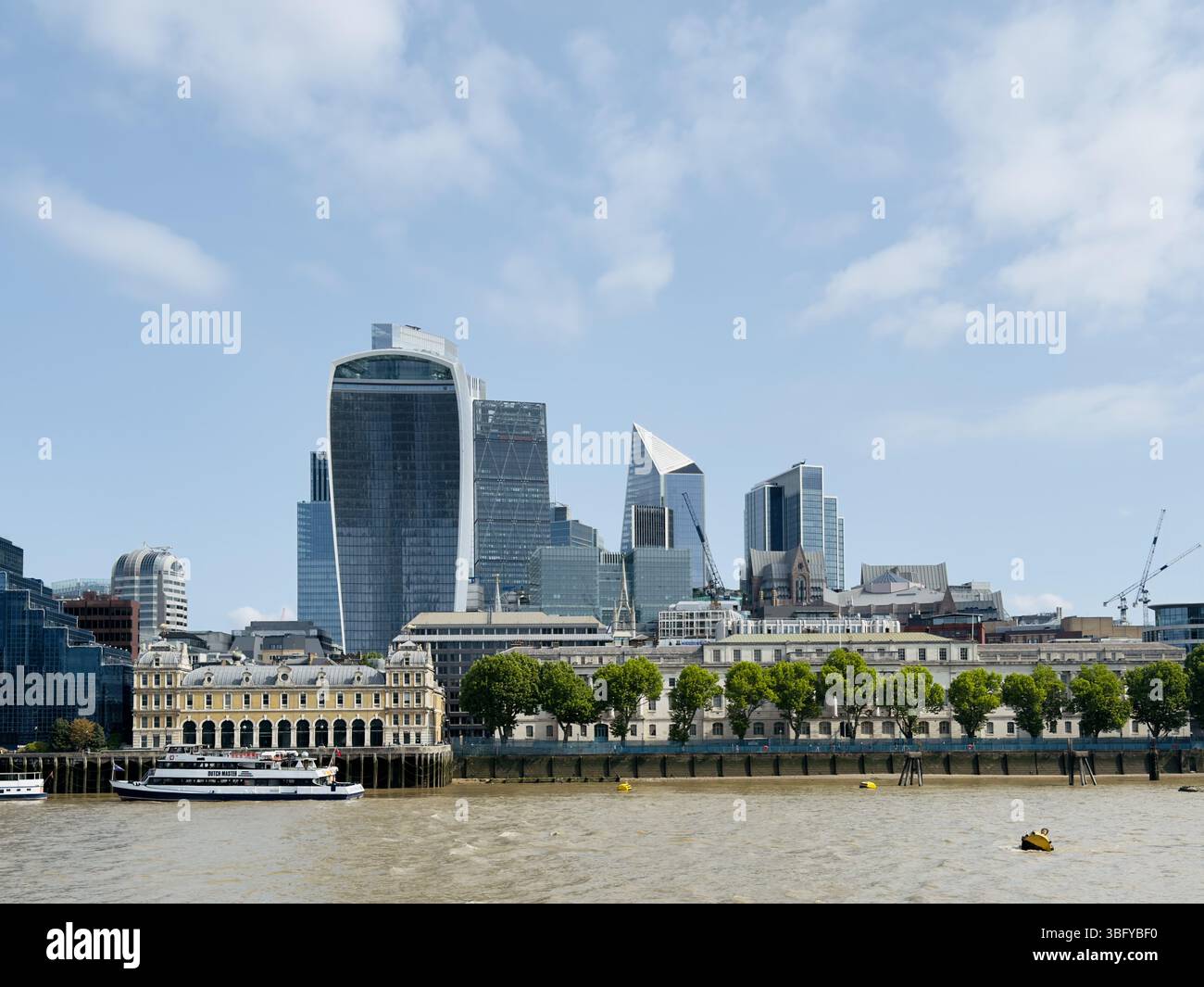 LONDON, ENGLAND – MAY 31, 2025: The City of London skyline, featuring modern skyscrapers and the Walkie Talkie building, viewed from across the River - Smartphone Captured Stock Image