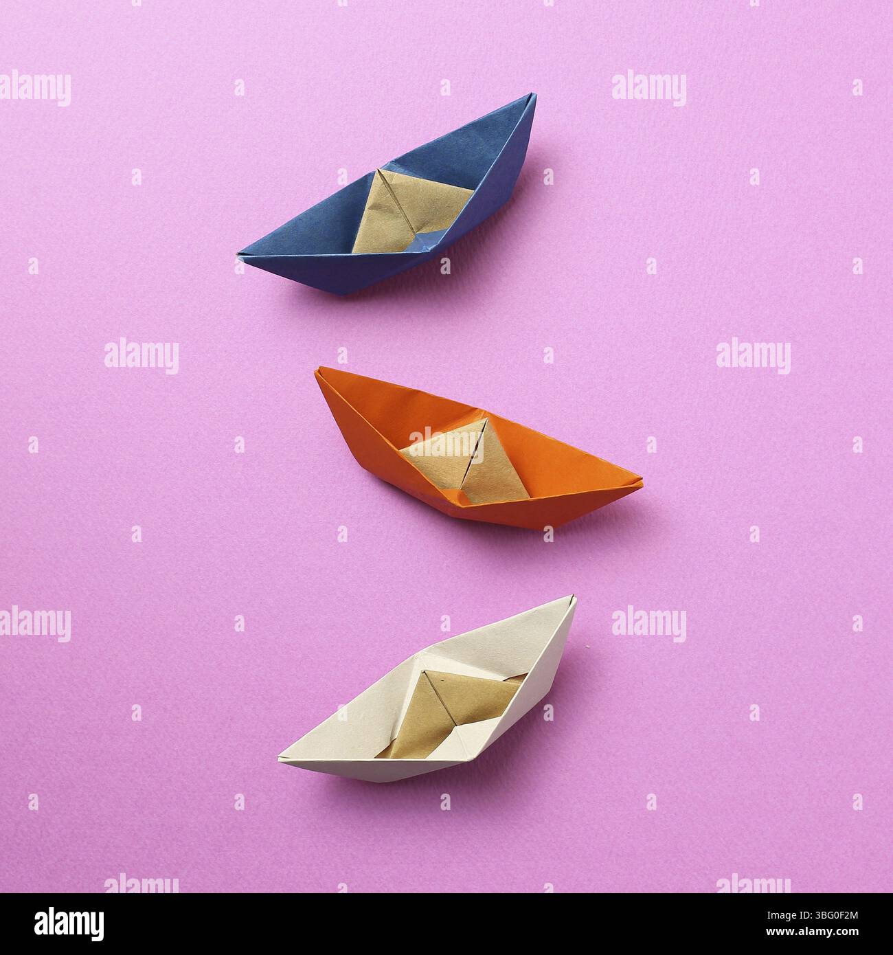 Paper ship on pink background Stock Photo