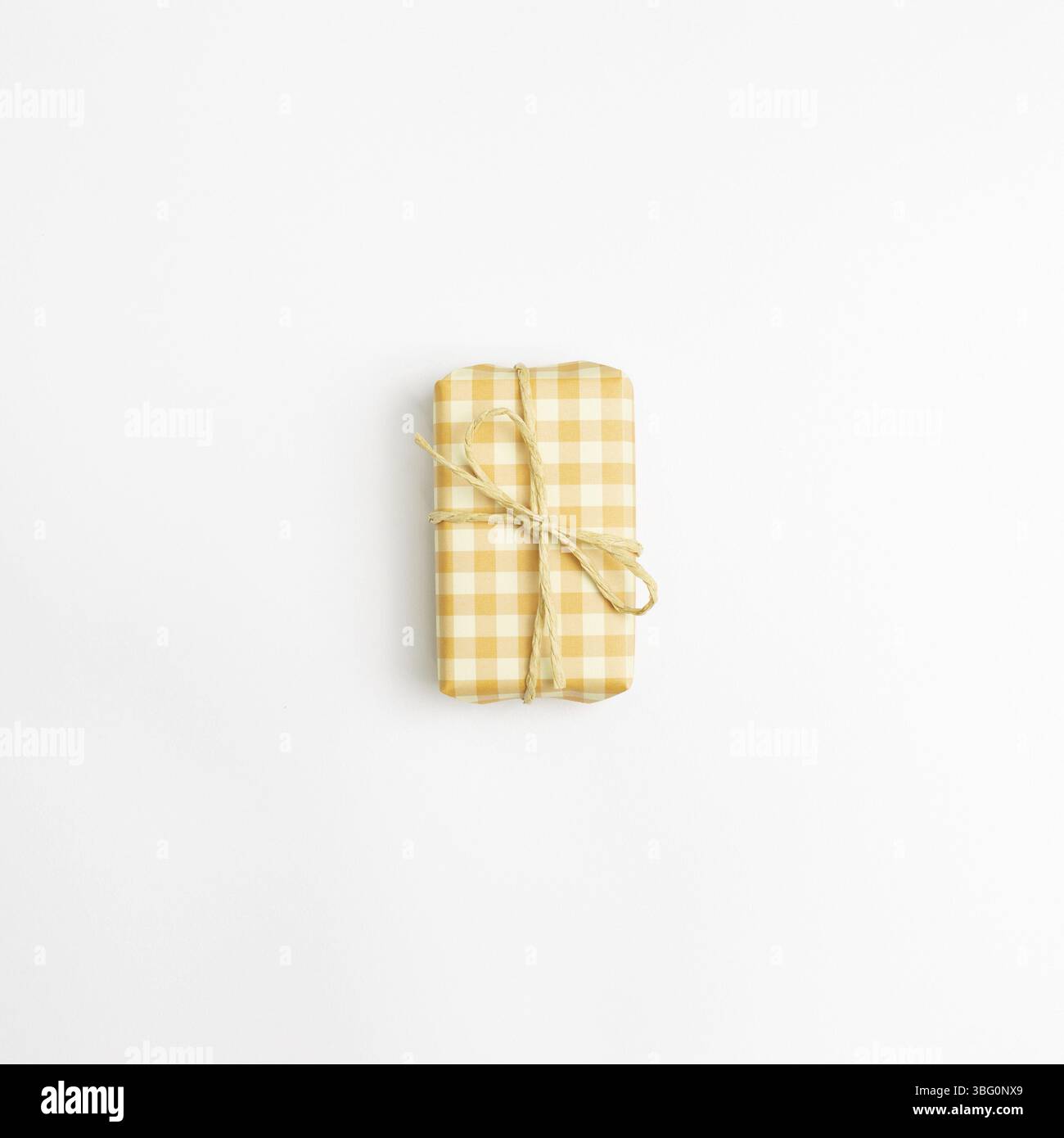 Yellow check pattern gift box isolated on white background. top view, copy space Stock Photo