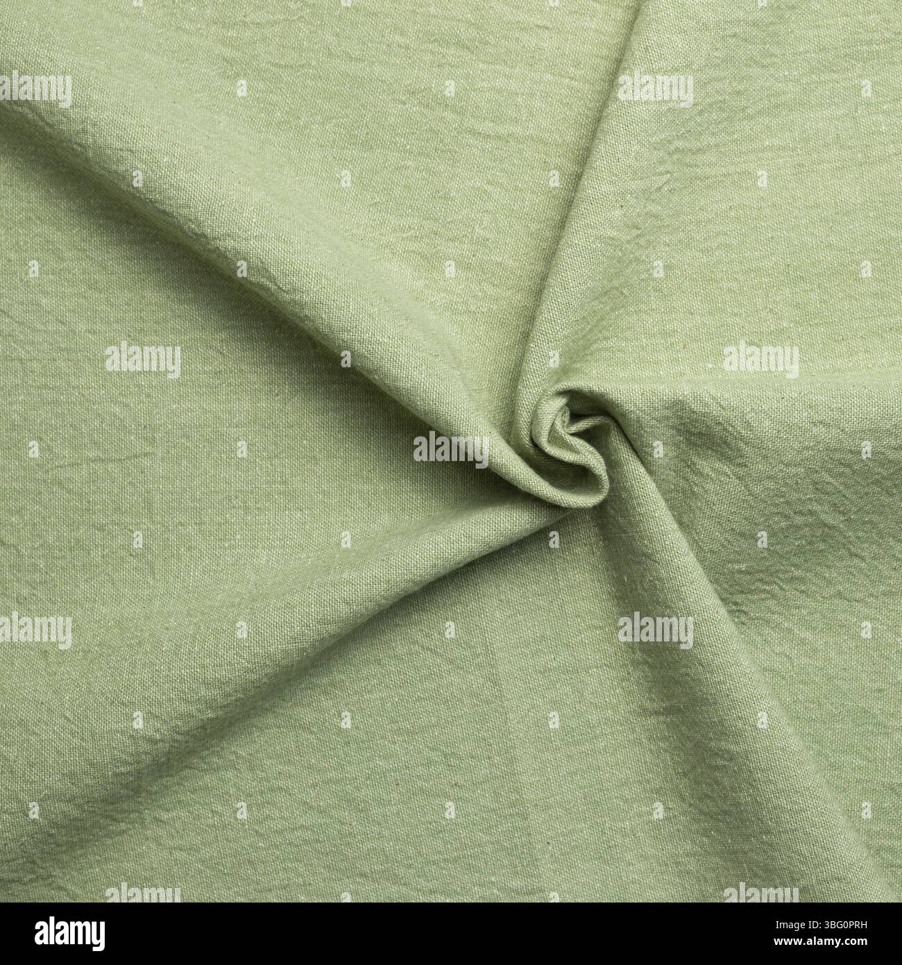 Crumpled natural green fabric texture background Stock Photo